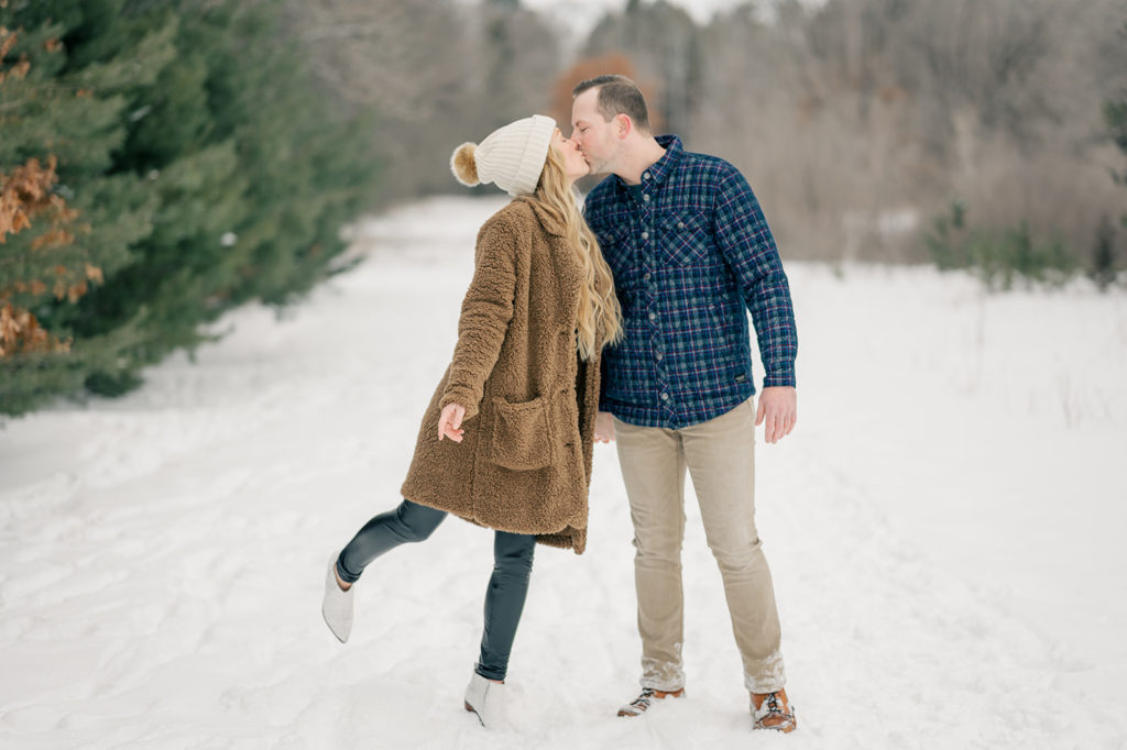 This couple sports cozy, cute outfits that are perfect for a wintry setting!