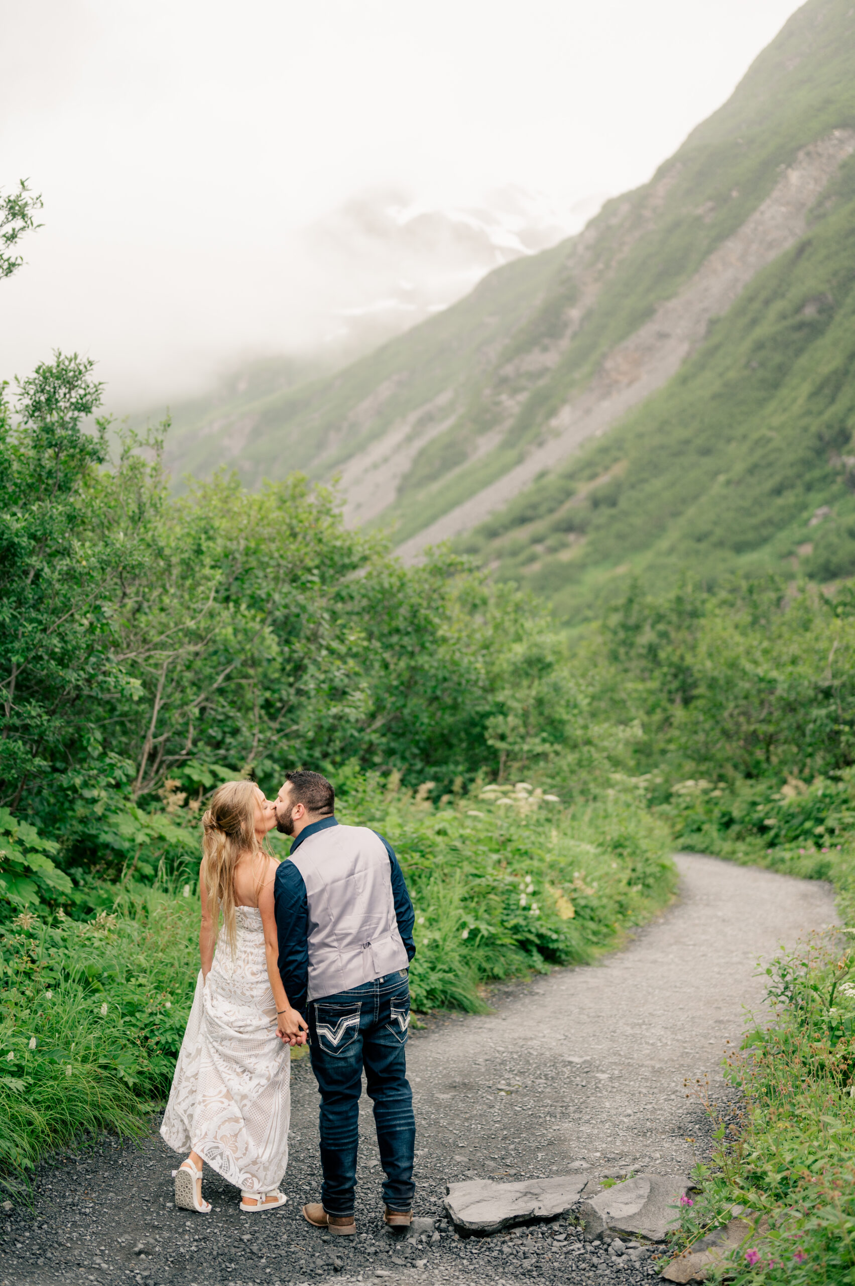 couple kisses while holding hands by Minnesota wedding photographer