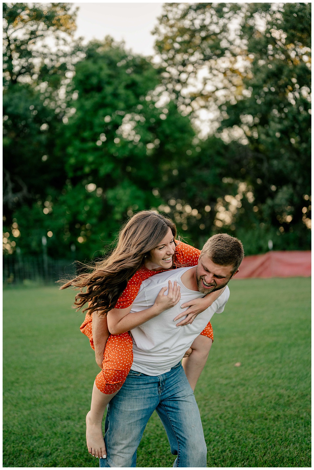  man and woman show the magic of engagement sessions as he carries her on his back while they laugh