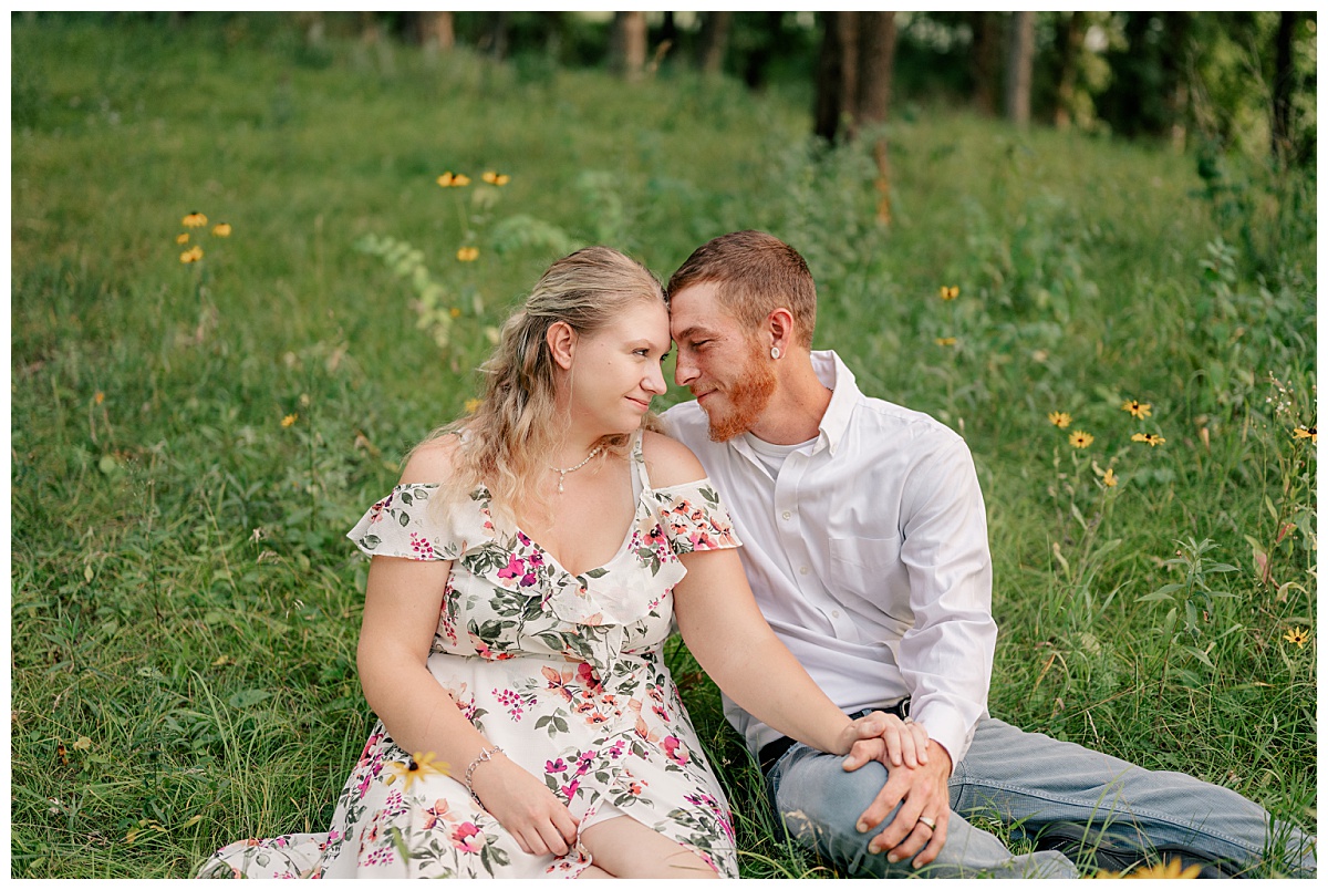 bride-to-be rests forehead on fiance's as they sit in meadow by Rule Creative Co