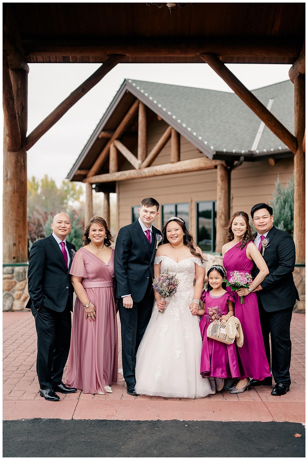 family gathers around newlyweds by Minnesota wedding photographer 