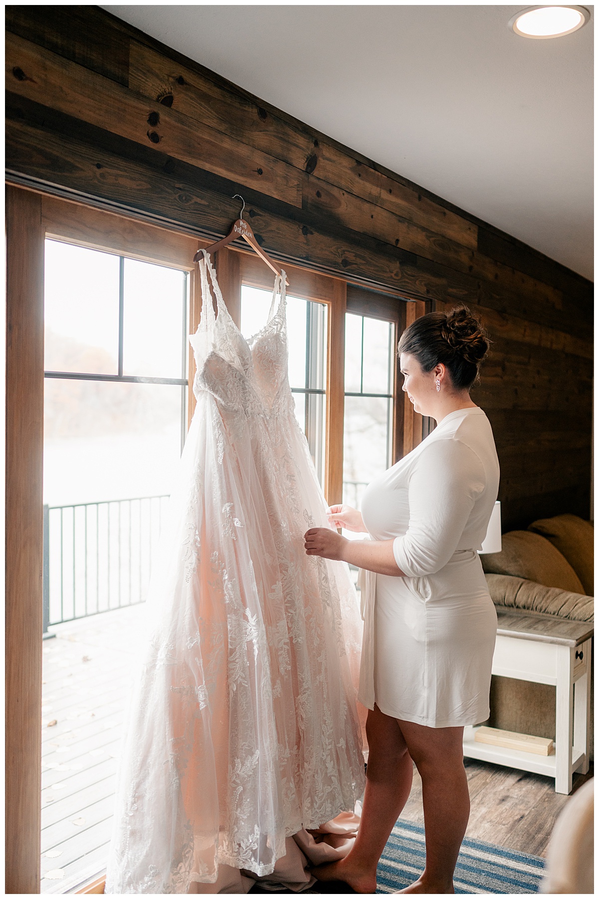 bride holds out her gown and looks at it as she keeps a relaxed wedding timeline