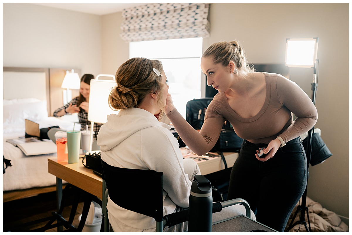 becoming an exceptional shooter is capturing makeup artist glamming up bride