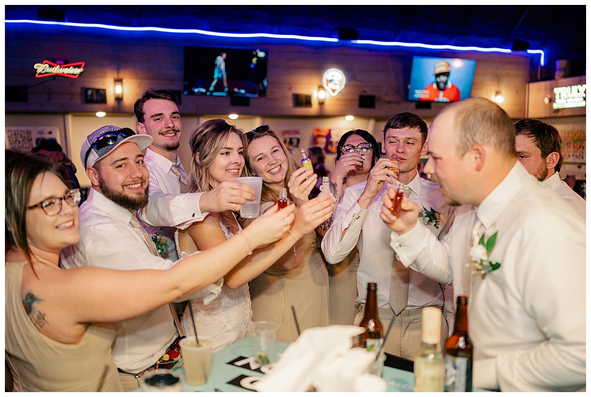 guests toast with the bride during reception by Rule Creative Co