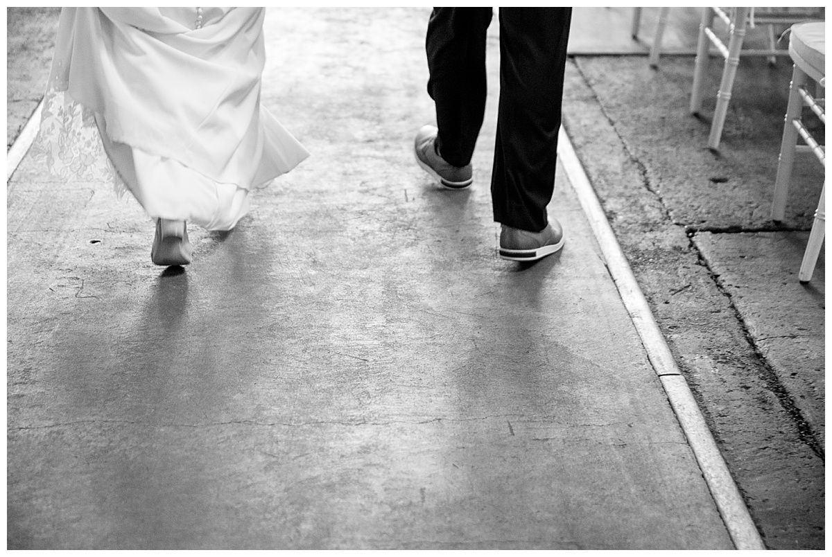 bride and groom's feet walk on path by Rule Creative Co