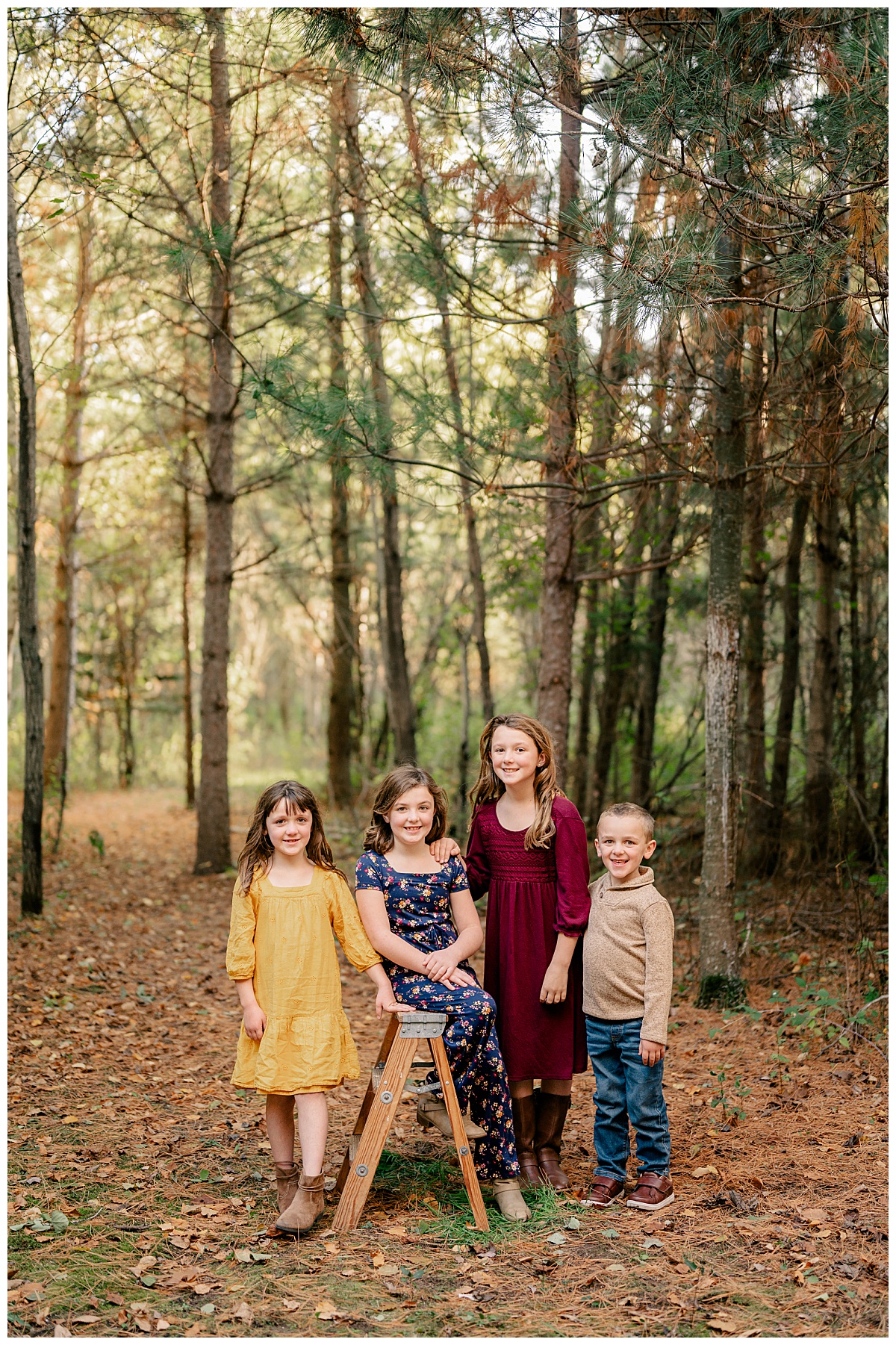 siblings smile in the woods during fall mini sessions