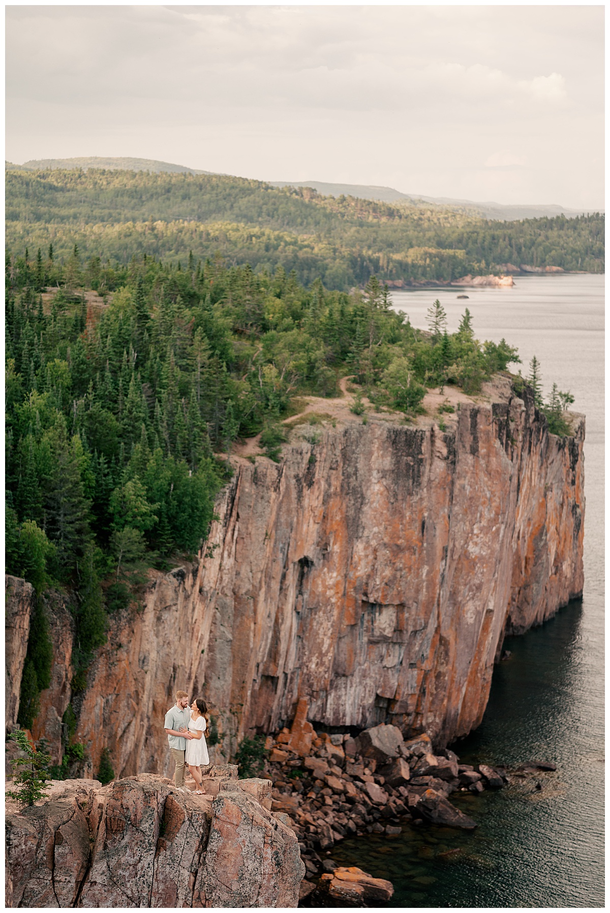 couple stands on cliffs on the North Shore in Minnesota by Rule Creative Co