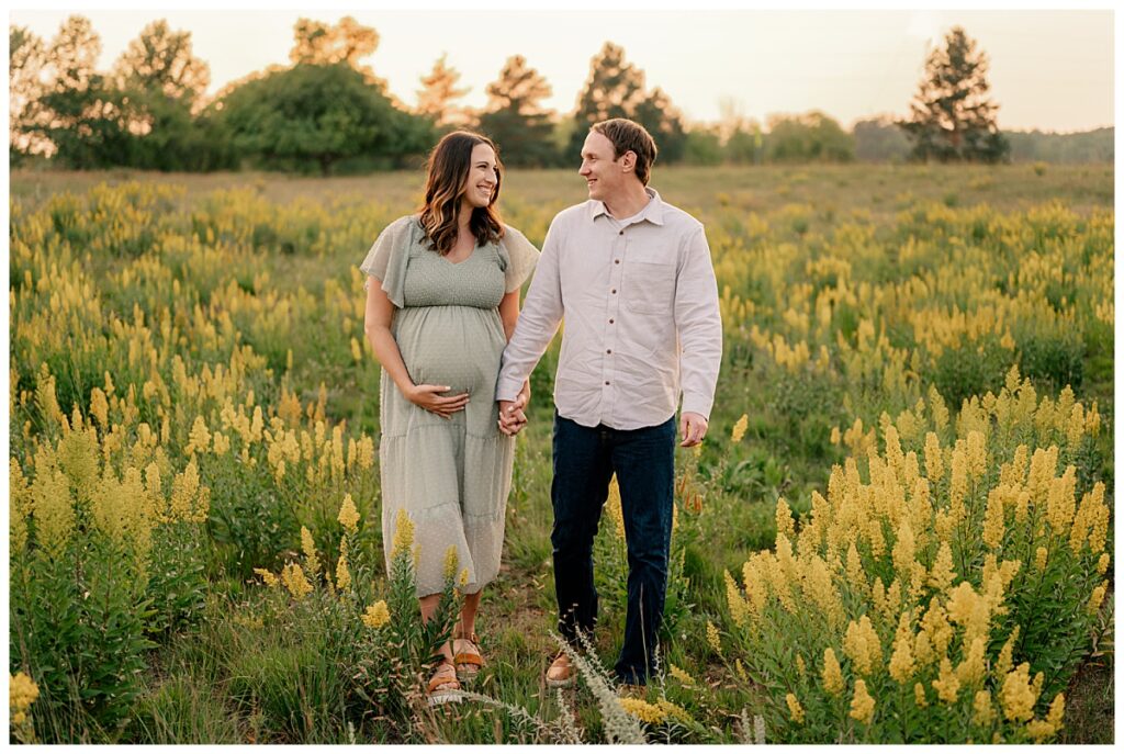 A Photographer’s Guide to Making Your Clients Comfortable in Every Session helps expectant parents smile at each other 