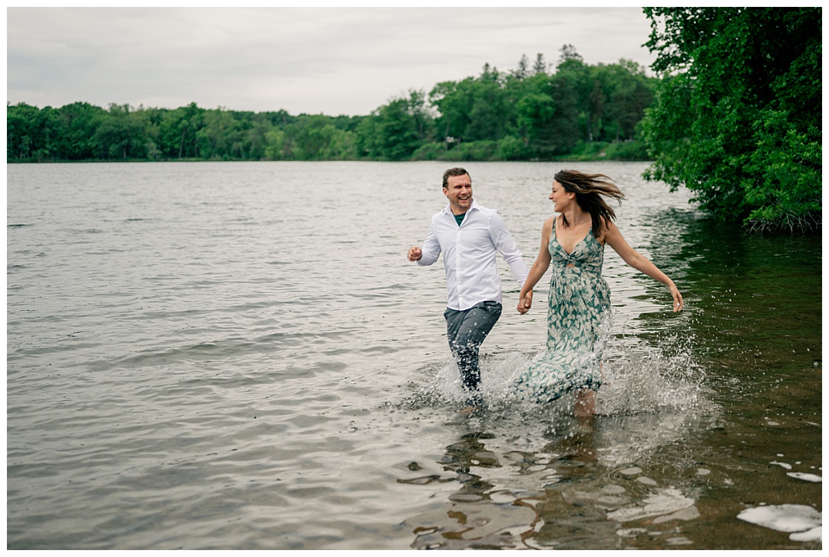 man and woman run through water on the edge of a lake by photographer sharing editing workflow