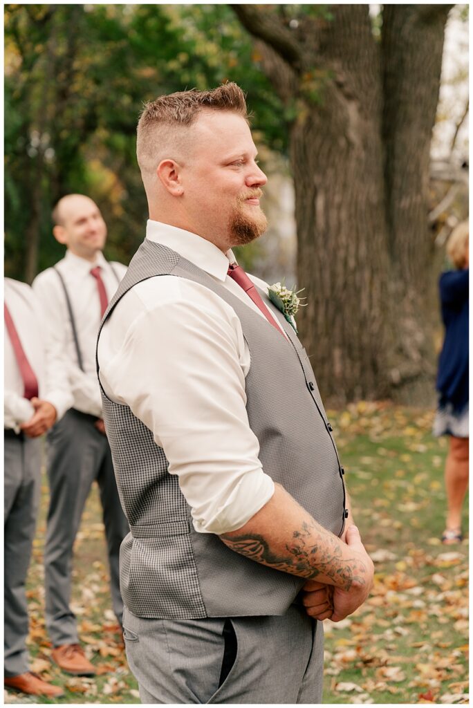 groom watches bride walk down aisle by Rule Creative Co