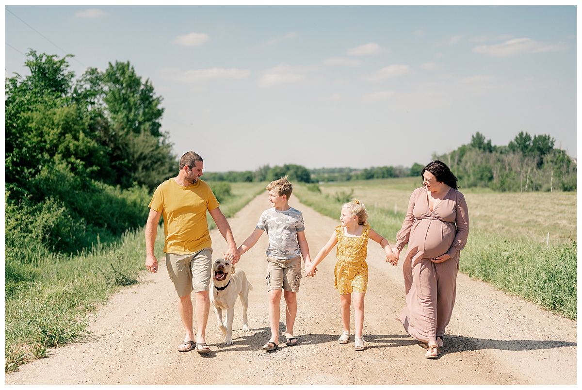 family walks holding hands for professional photos