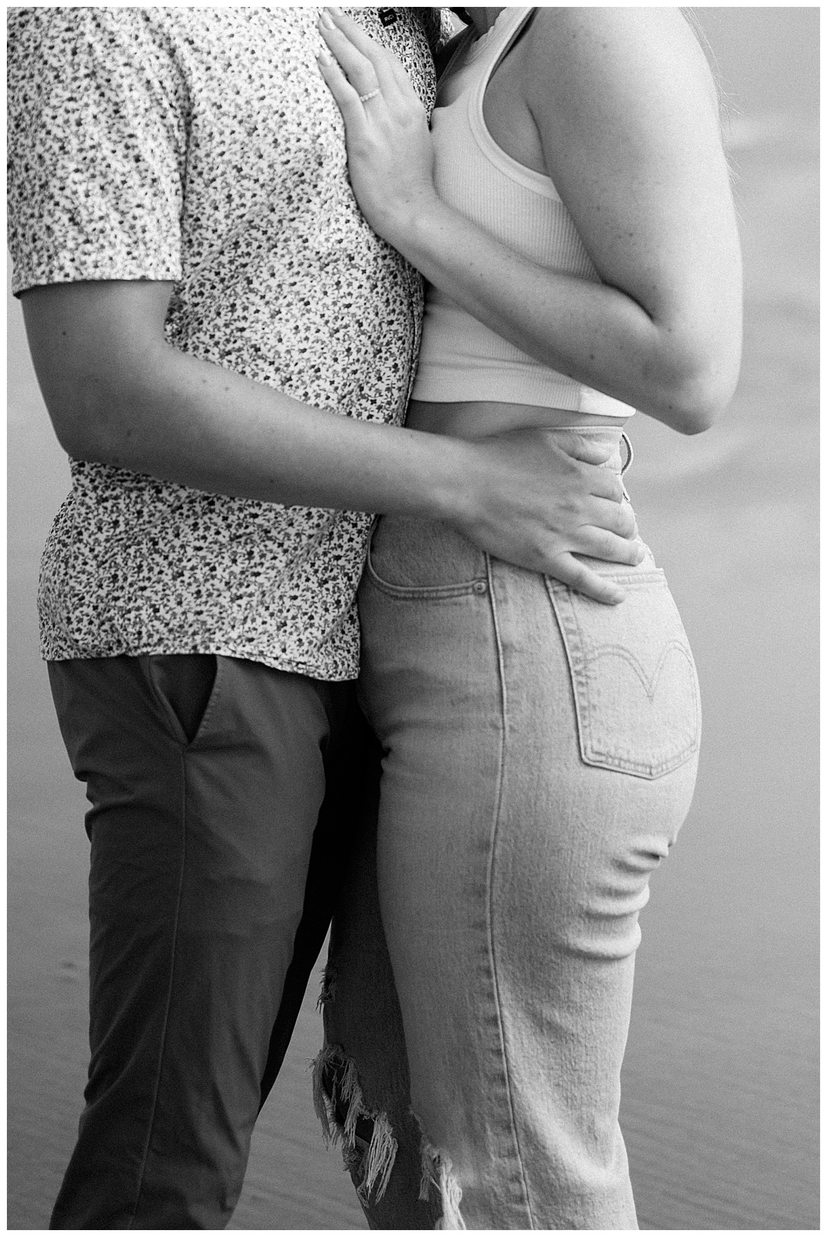 man holds woman's waist by Minnesota photographer