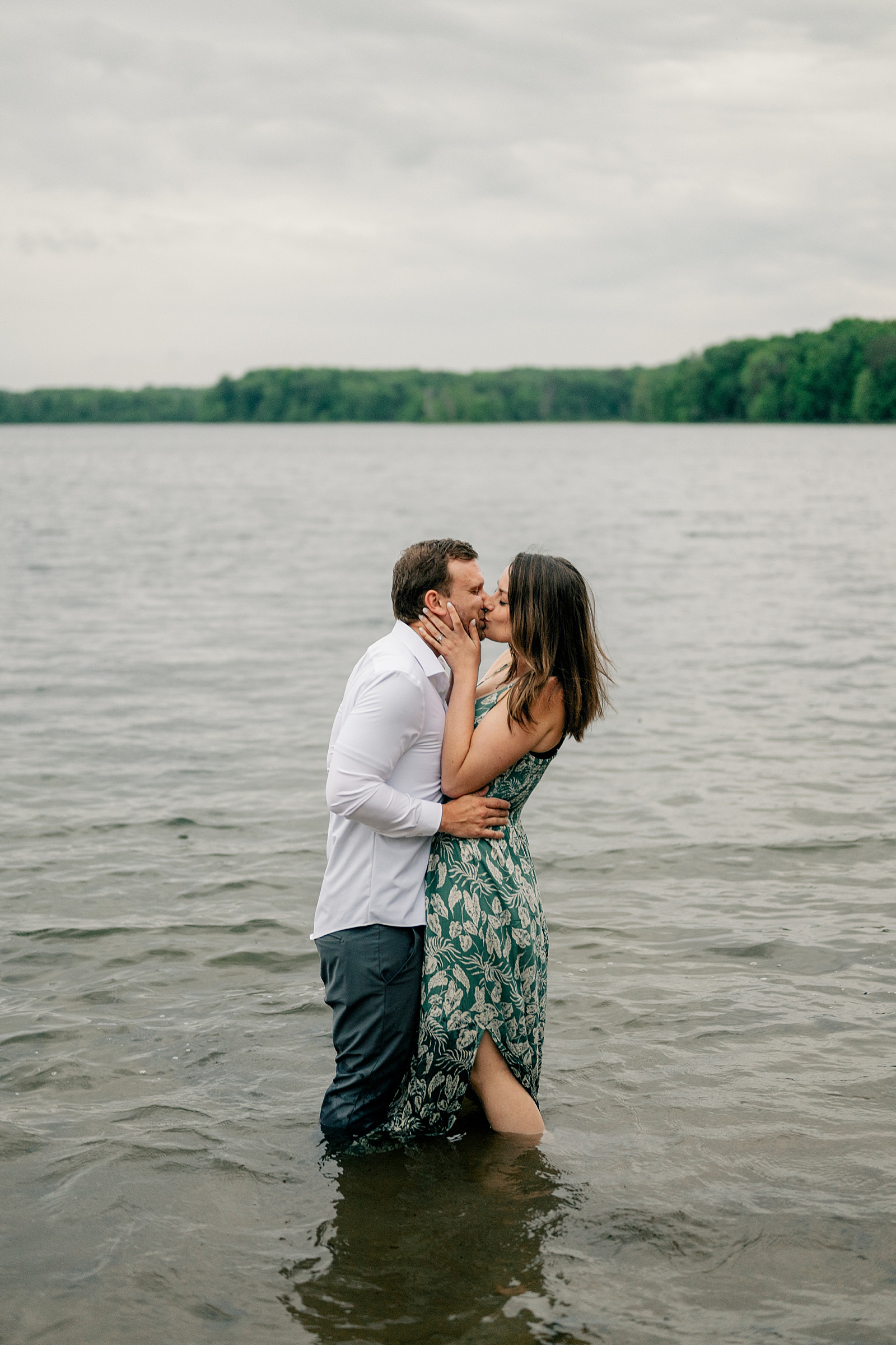 engaged couple kiss in the water by Minnesota wedding photographer