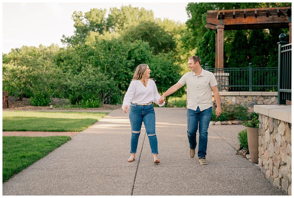 couple walks hand in hand at Plymouth Community Center 