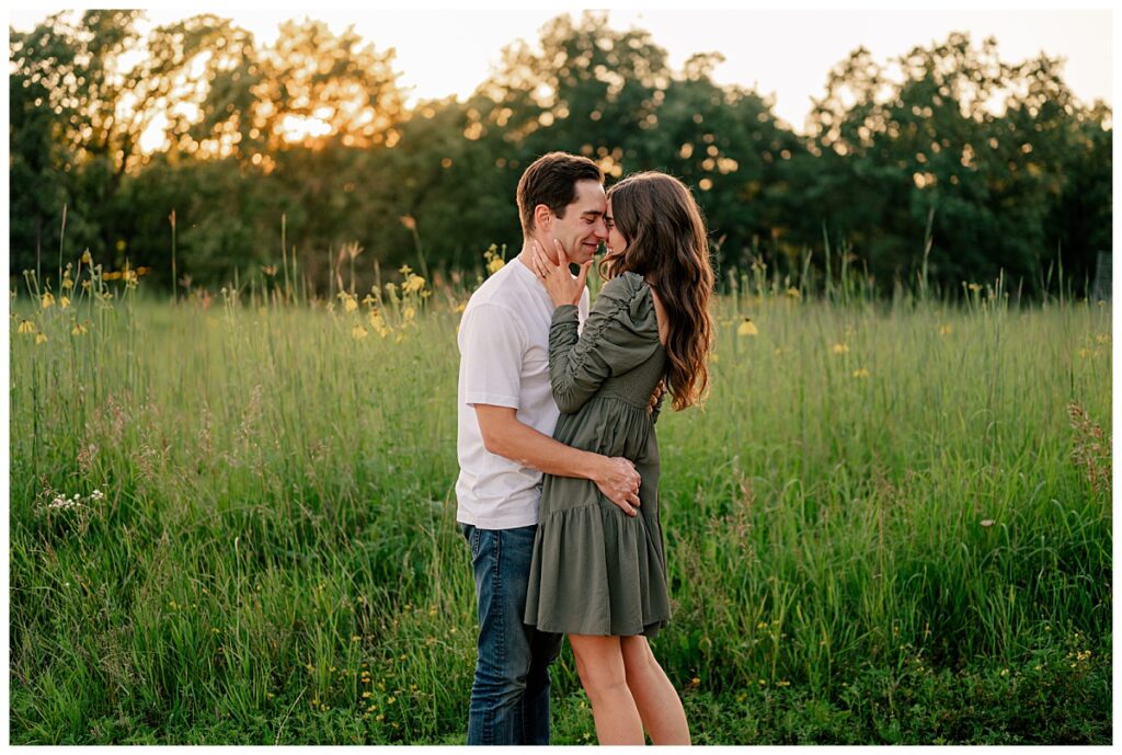 man holds woman around the waist during golden hour St. John's engagement 