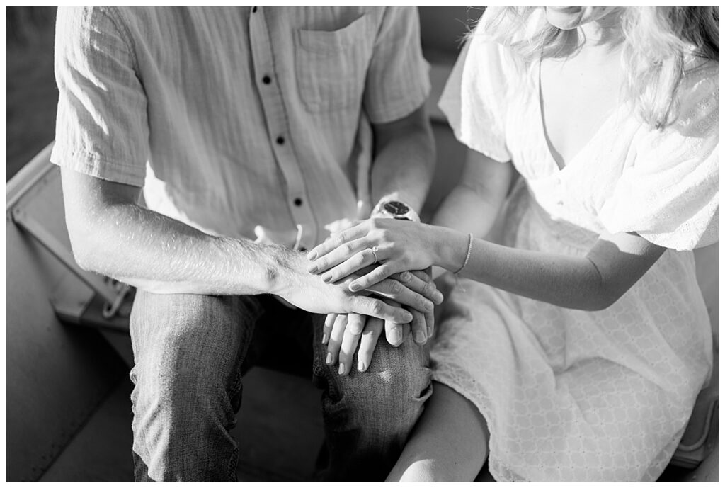 couple rests hands on his knee to show off engagement ring by Minnesota wedding photographer