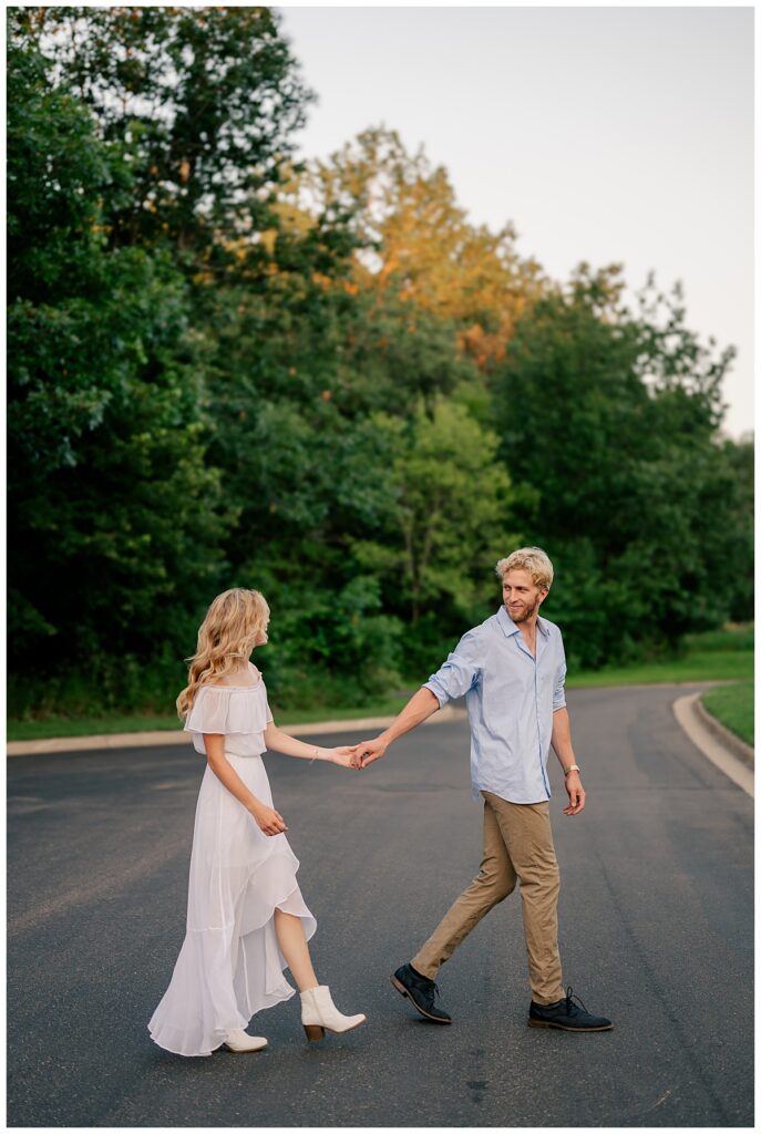 man leads bride to be across the street by Rule Creative Co