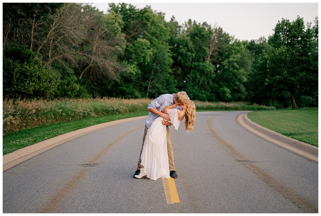 man dips his bride to be by Minnesota wedding photographer