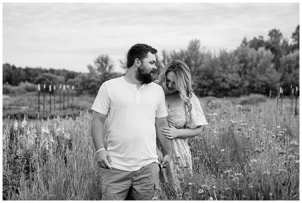 wife looks down as she holds husband's arm by Minnesota photographer