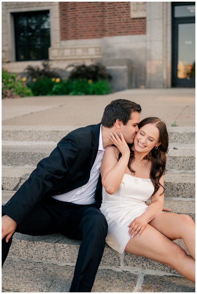 man kisses bride-to-be on steps by Rule Creative Co