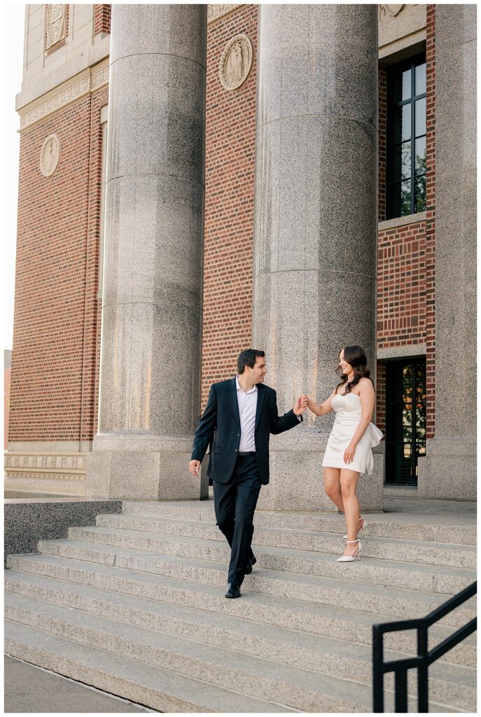 man helps woman down steps by Minnesota wedding photographer