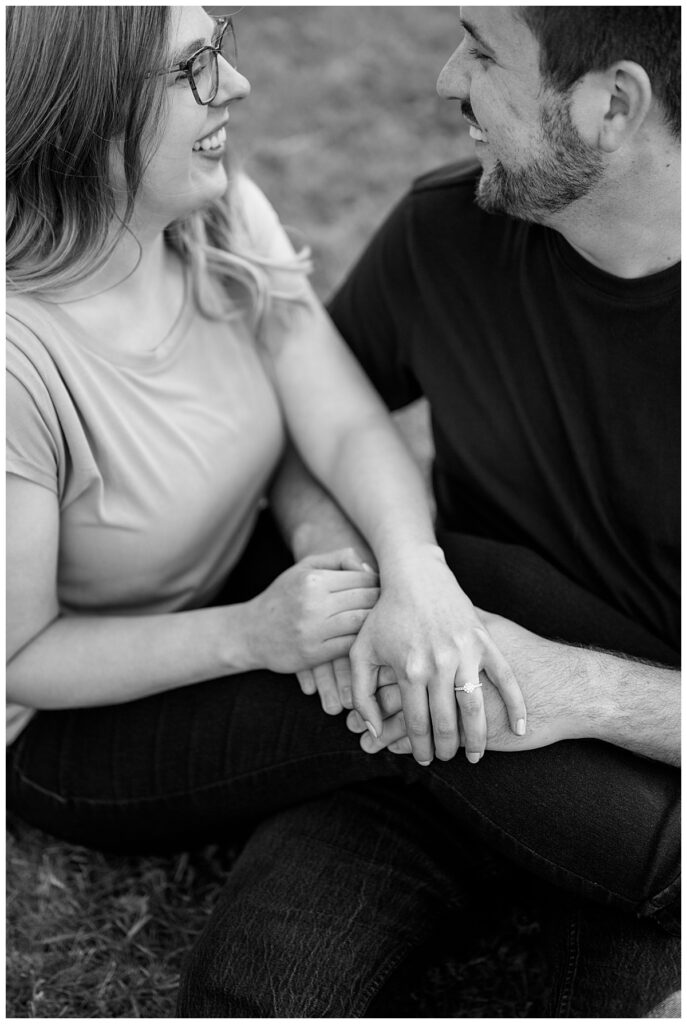 engaged couple smiles as they look at each other by Rule Creative Co