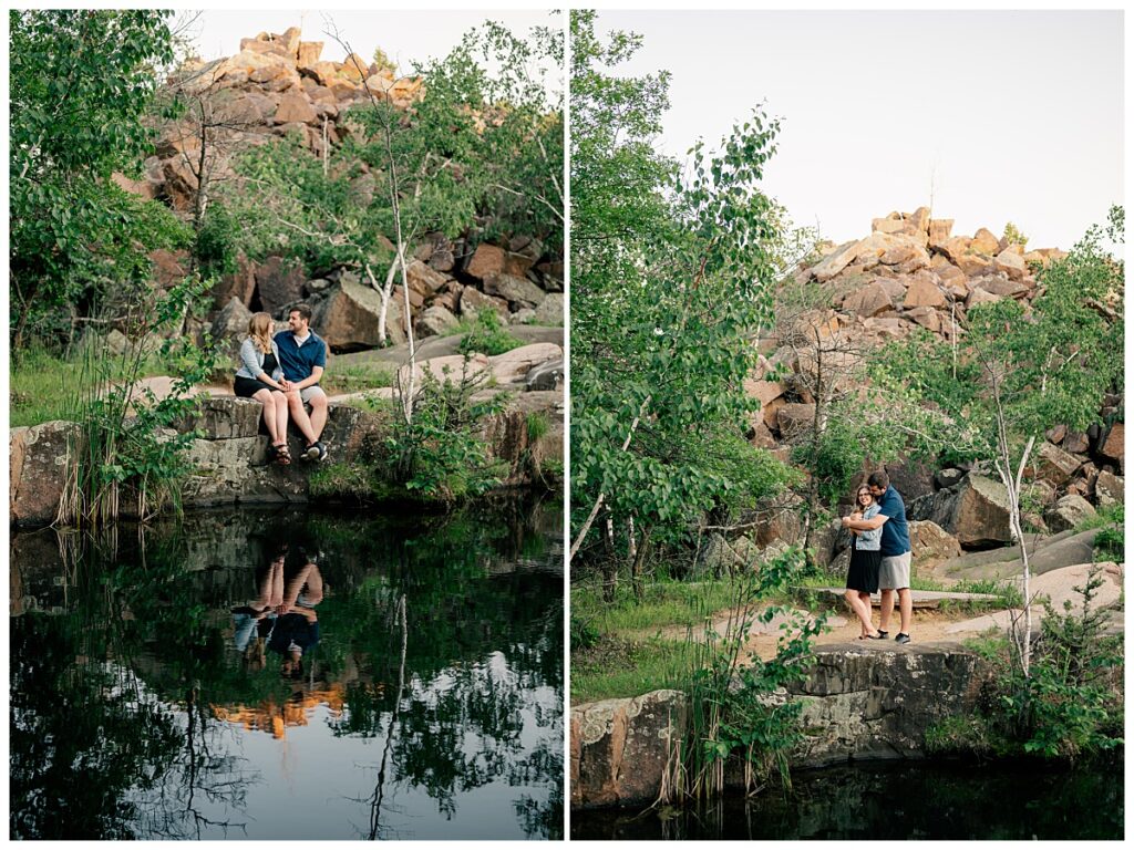 man and woman sit on rock above lake at Quarry Park evening engagement session 