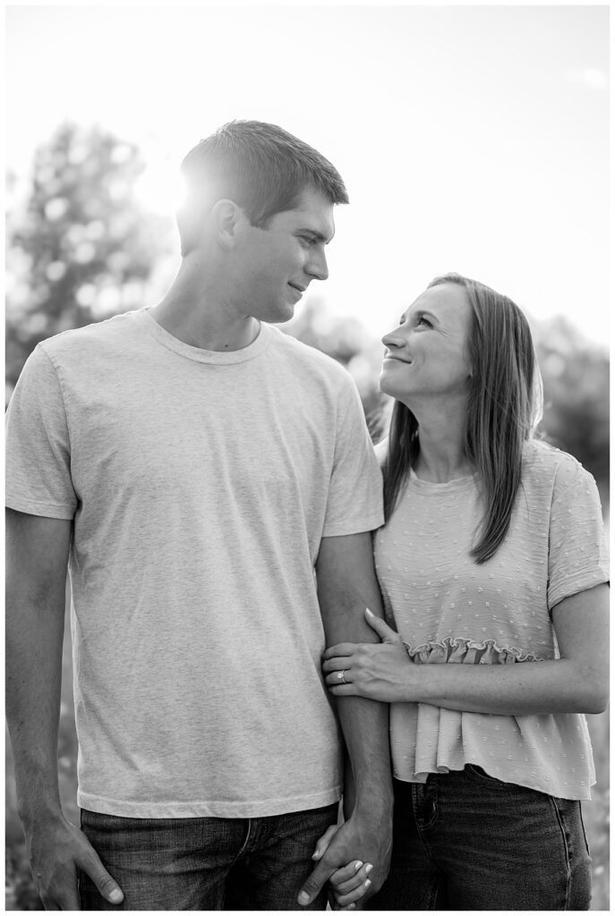 bride to be holds her fiancé's hand while she smiles at him by Rule Creative Co