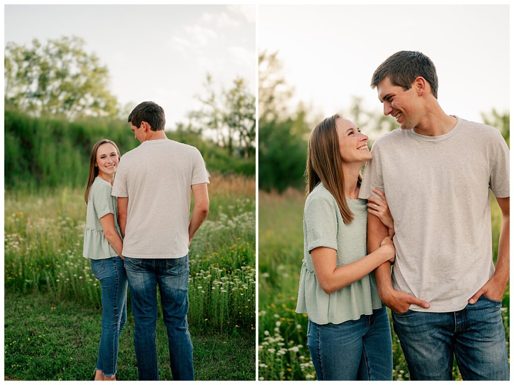 woman holds her fiancés arm as they smile at each other by Minnesota wedding photographer