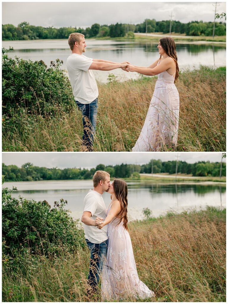 man and woman kiss in front of lake at St. John's Arboretum mini session