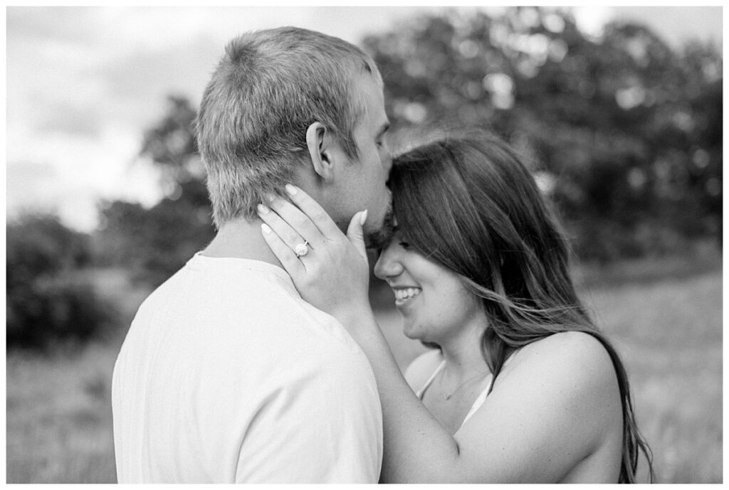 husband kisses wife's forehead by Minnesota couples photographer