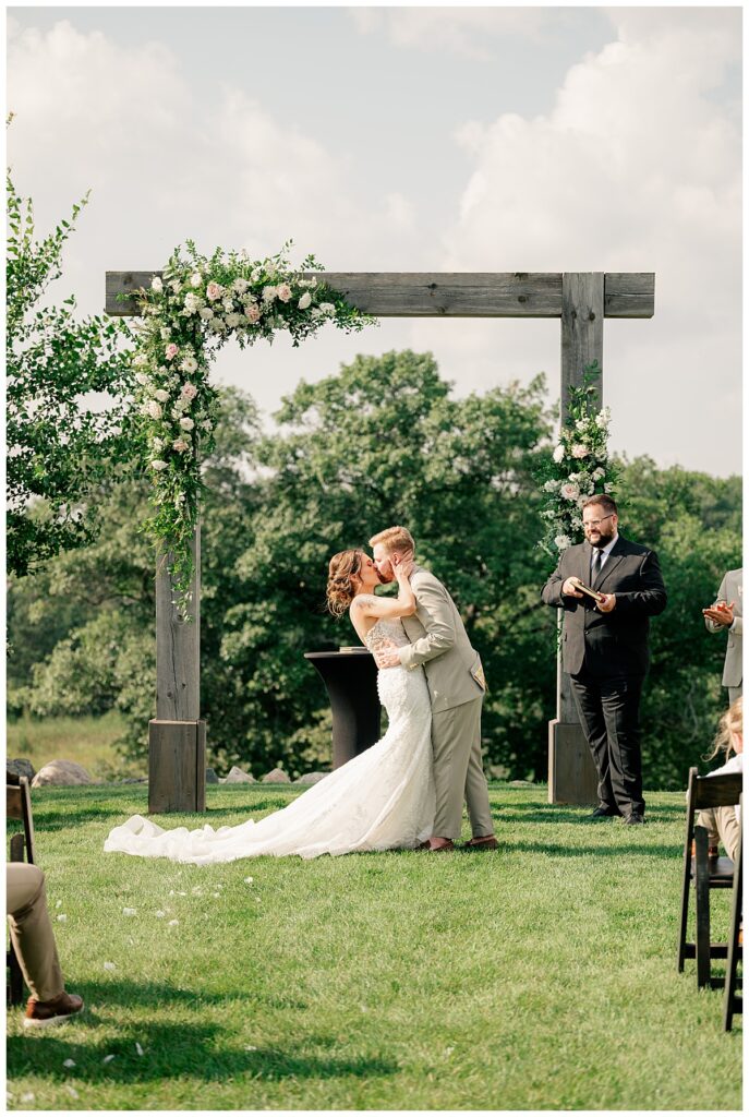 couple shares first kiss by Minnesota wedding photographer