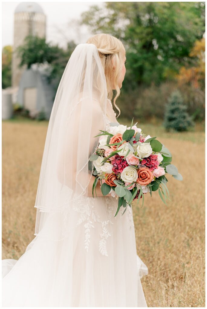 bride looks over her shoulder thinking about why your wedding timeline matters 