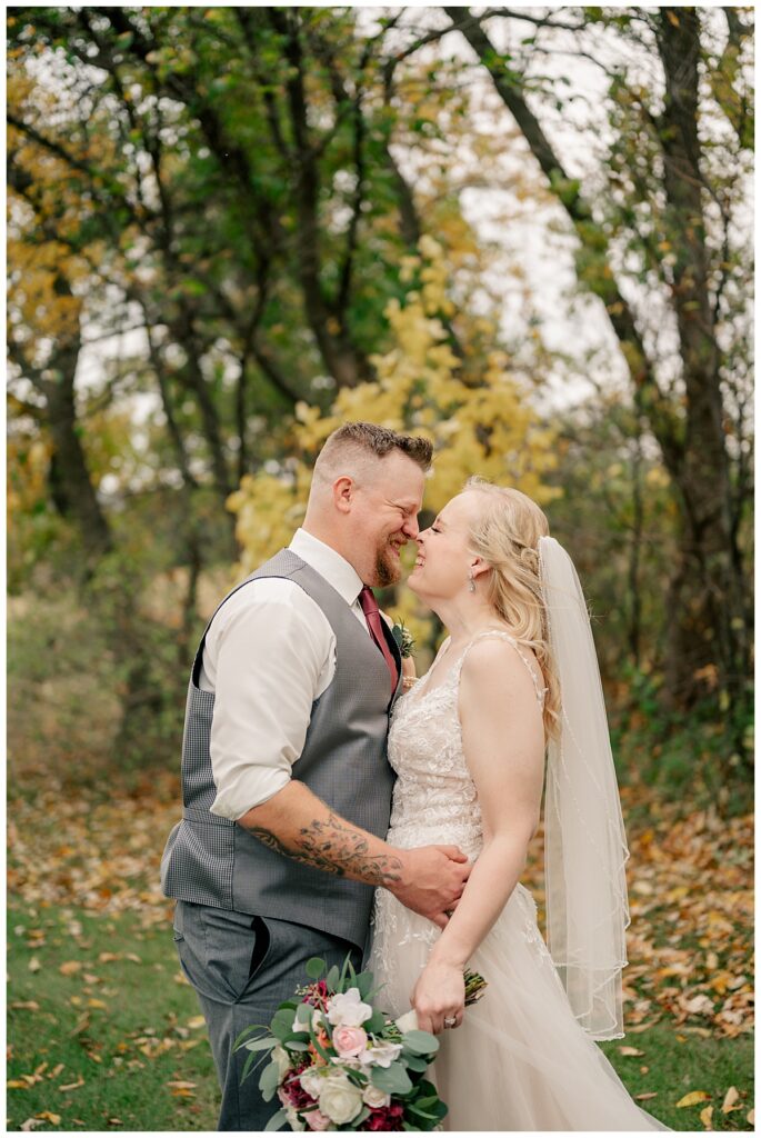 bride and groom smile while they touch noses thinking about why your wedding timeline matters 