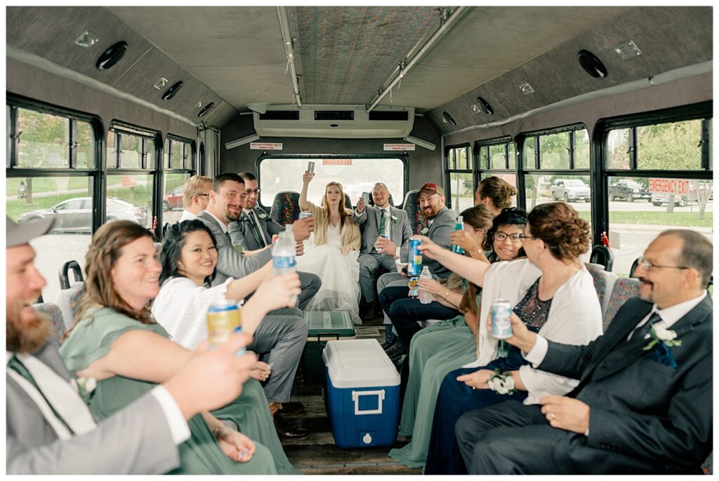 couple explores why your wedding timeline matters as they celebrate with guests on a party bus