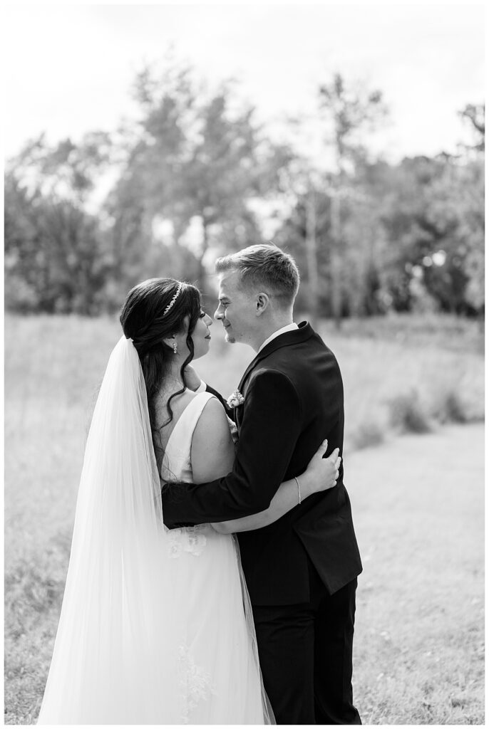 couple leans in for a kiss by Minnesota wedding photographer