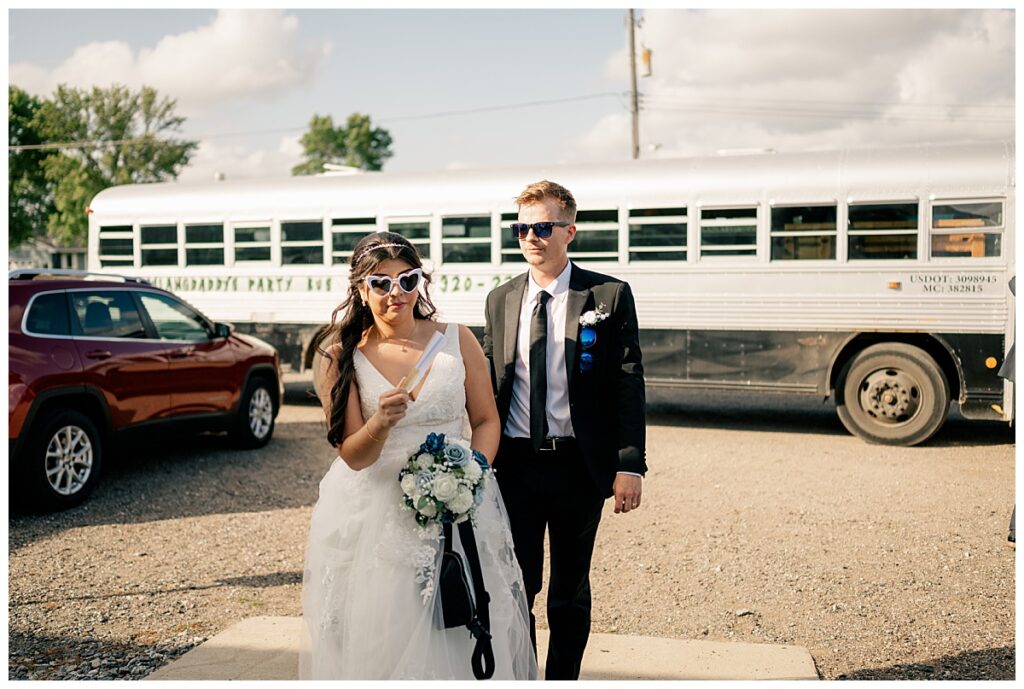 bride and groom walk into ceremony from the party bus by Rule Creative Co