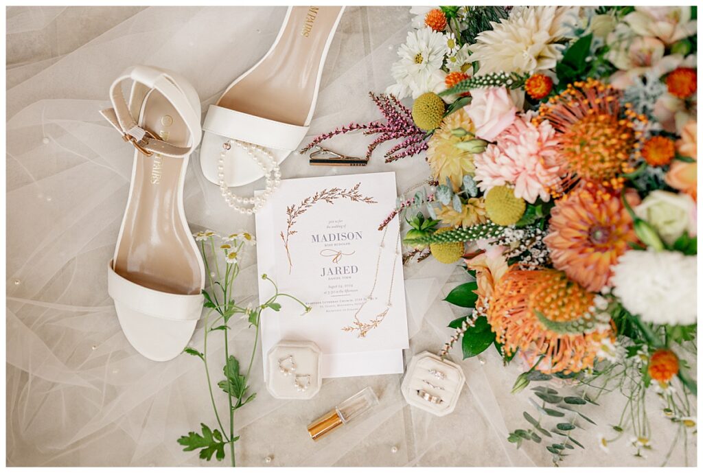 flat lay of bridal details and invitation to Northern Oaks summer wedding