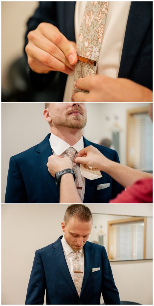 groom gets ready adjusting his tie and by Minnesota wedding photographer