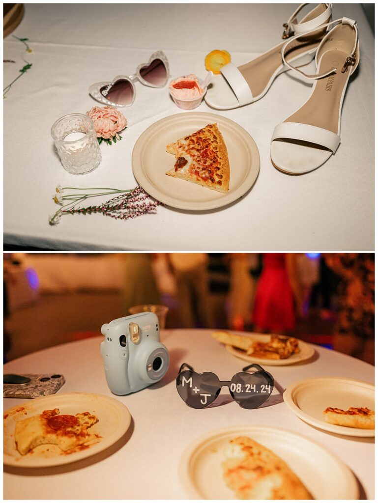 plates of pizza sit at reception with camera and bridal details by Minnesota wedding photographer