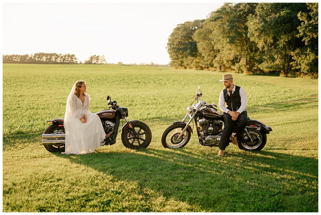 bride and groom sit on motorcycles looking at each other as sun sets by Rule Creative Co