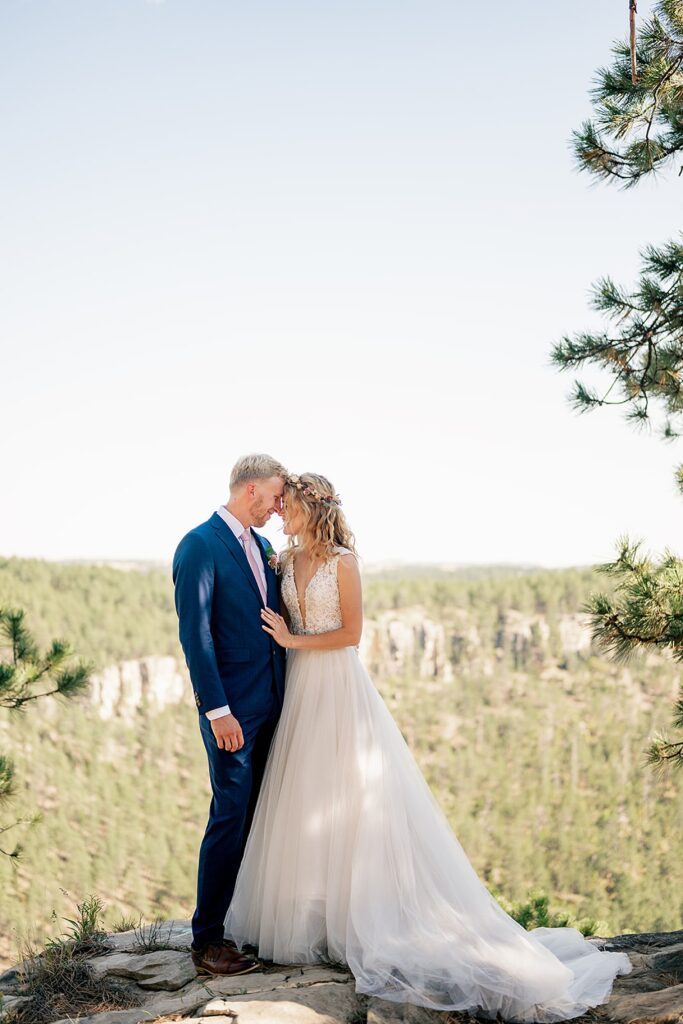 bride and groom embrace with beautiful backdrop of black hills elopement 