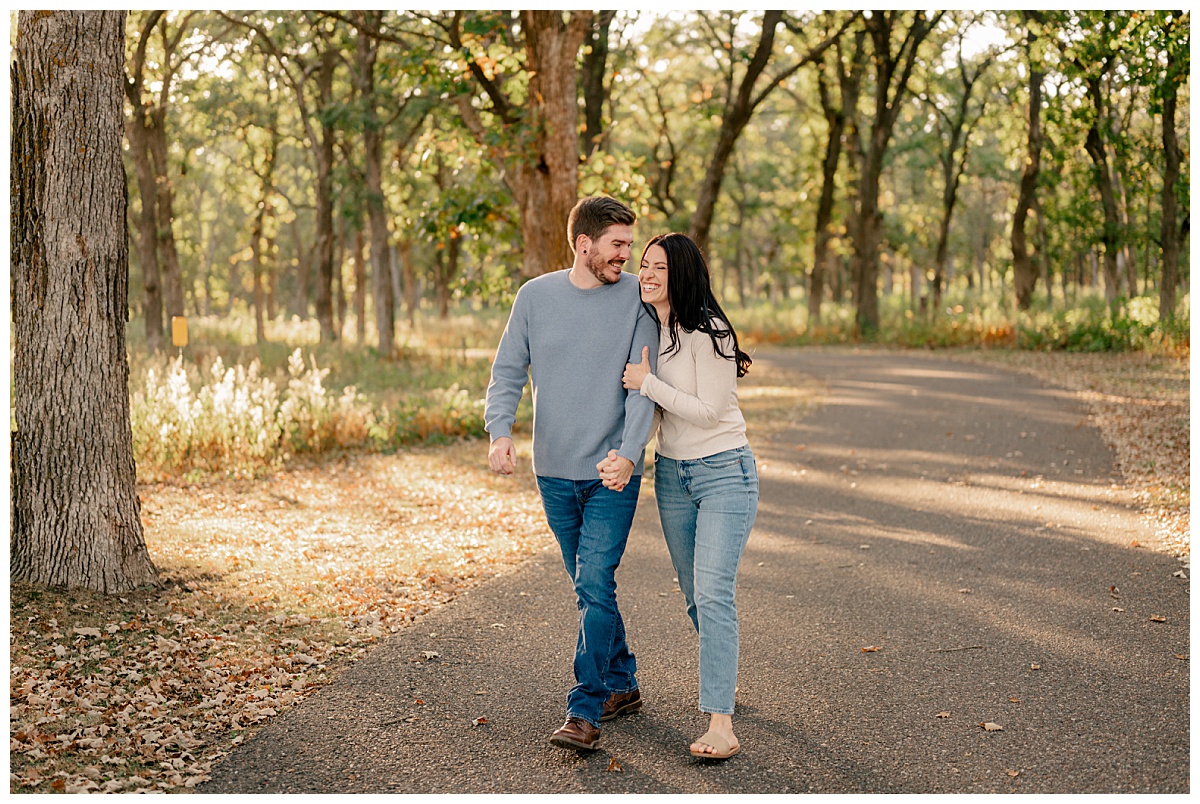 couple in blue jeans giggle in Belle Prairie Park