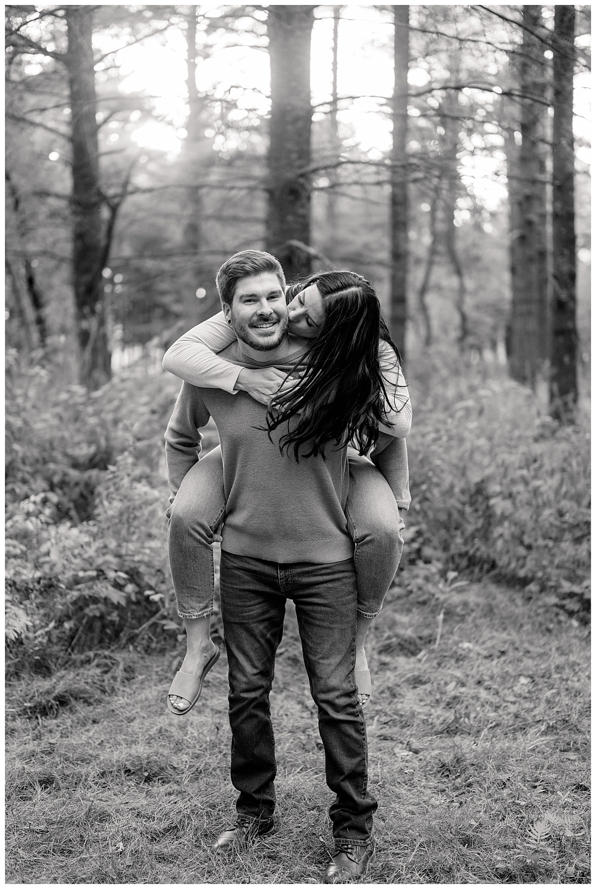 bride to be jumps on fiancé's back by Minnesota wedding photographer