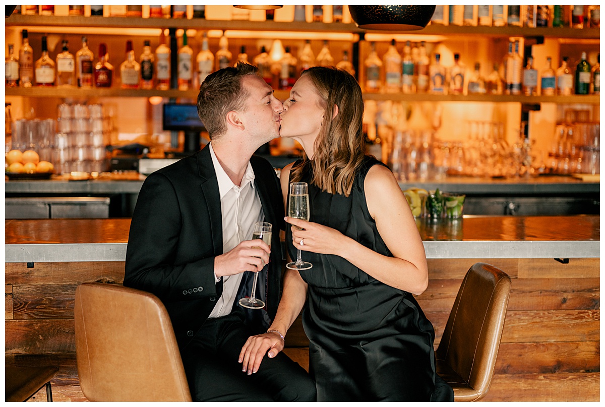 couple kiss at the bar at Hewing Hotel