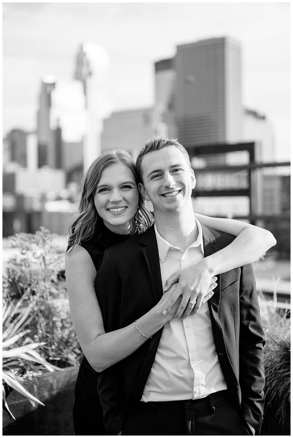 woman wraps arms around her fiance by Minnesota wedding photographer 