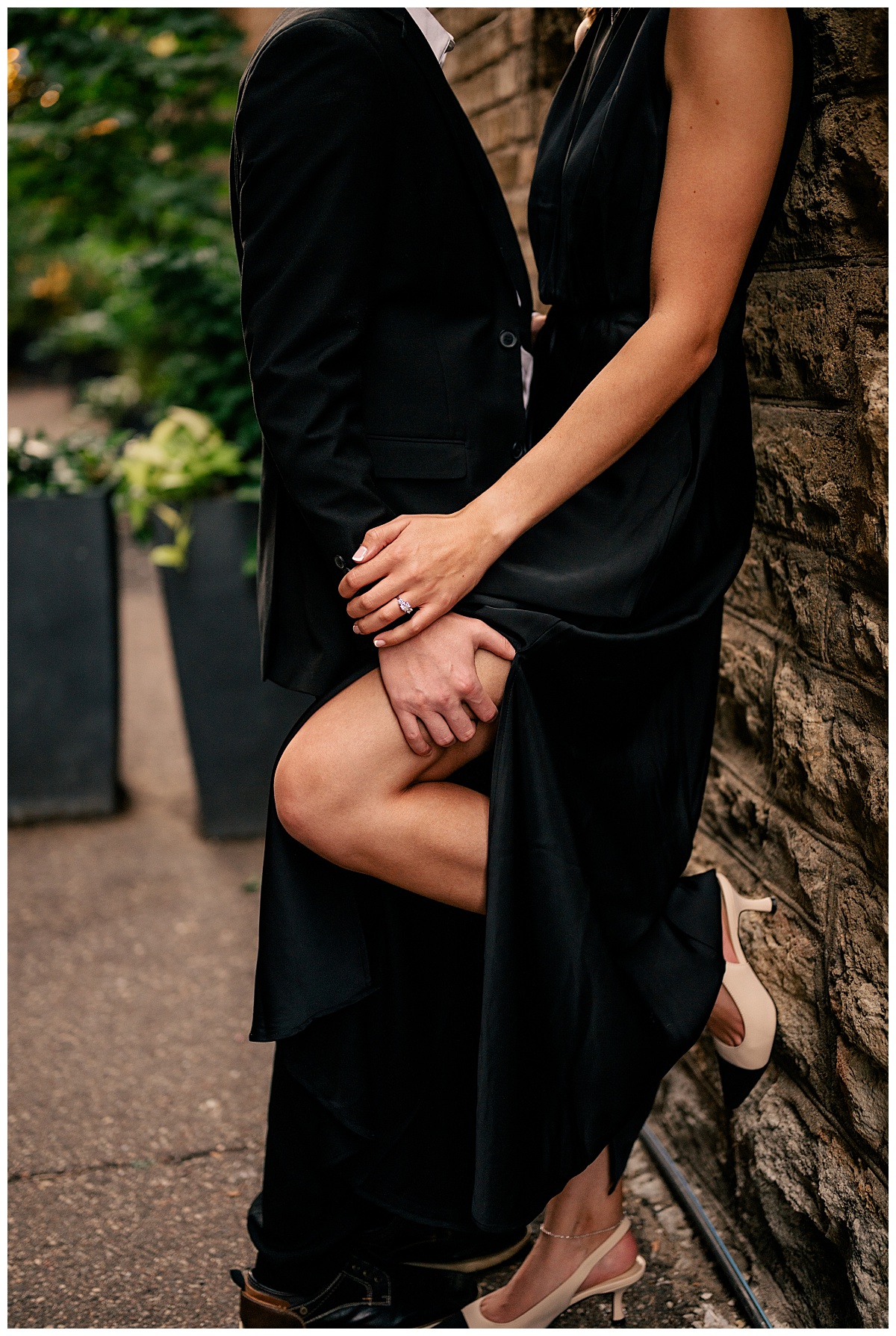 groom holds brides leg against wall at Hewing Hotel