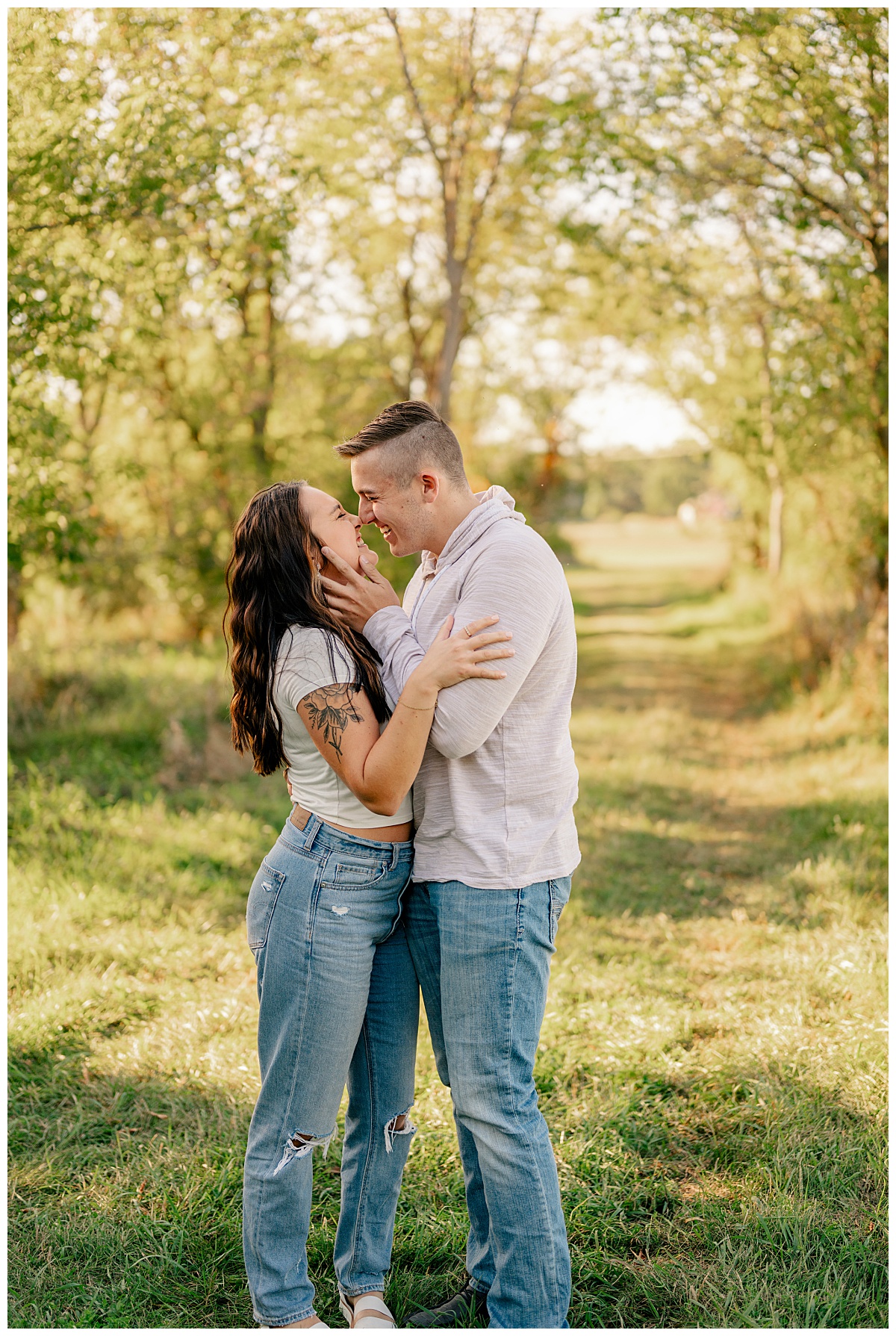 man leans in to kiss his woman during golden hour by Rule Creative Co