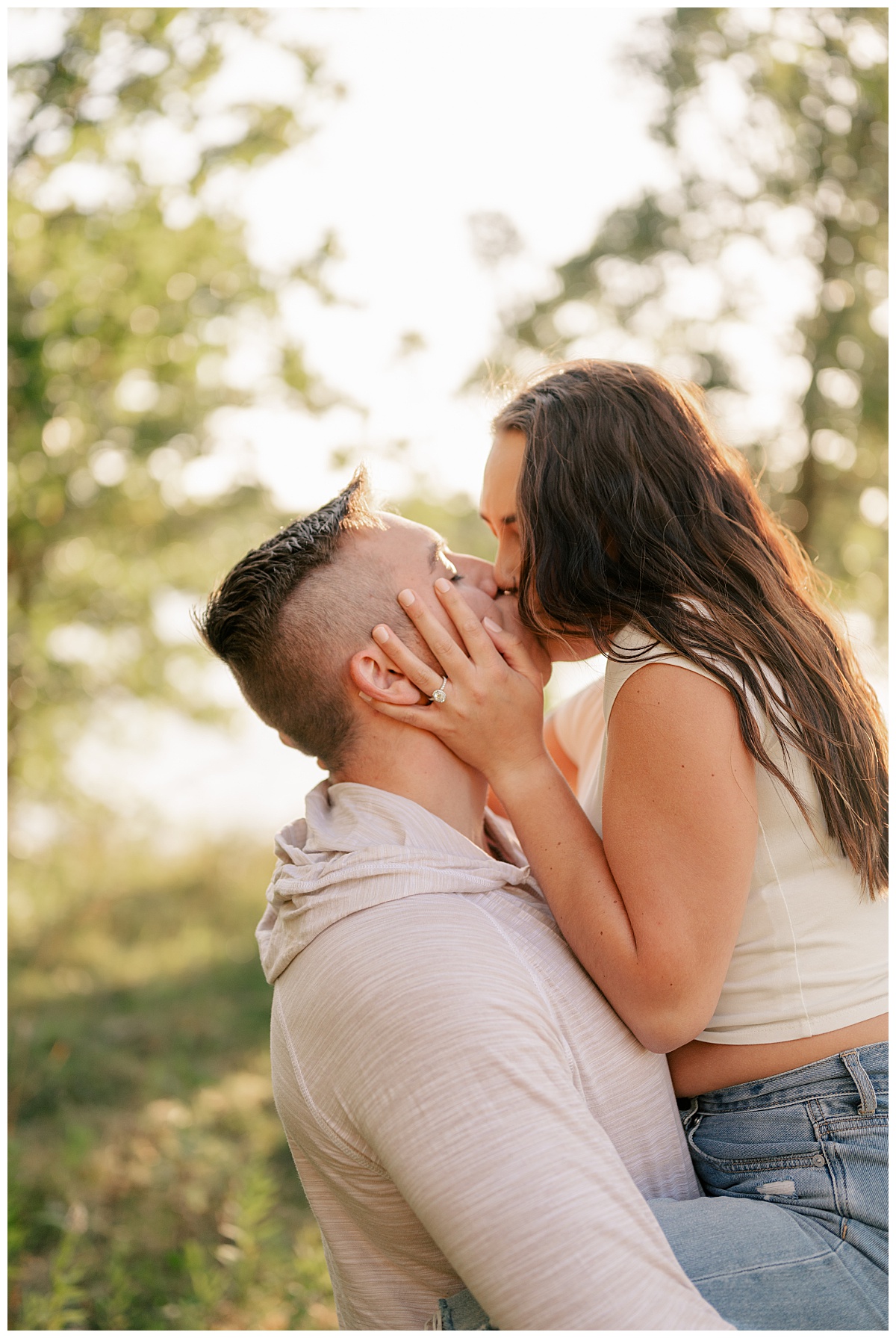 couple kisses by the lake at golden hour by Rule Creative Co