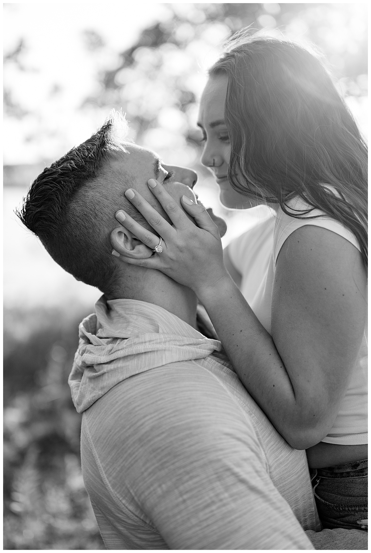 man and woman about to kiss for playful St. John's engagement shoot